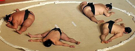 Sumo wrestlers stretching